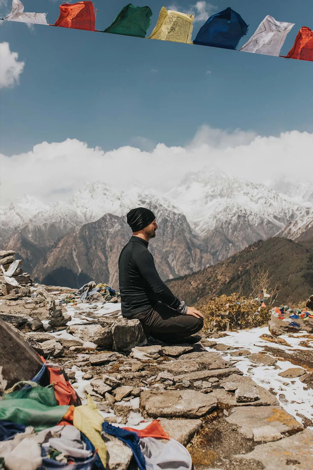 My Daily Routine for Freelancers: Leo Grzyb meditating on the top of a mountain in the Himalayas